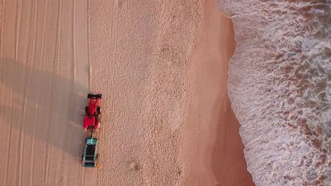 Aerial-shot-of-beach-tracktor-cleaning-manly-beach