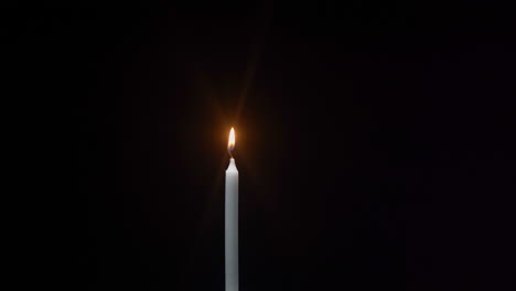 lighting-a-candle-in-dark-place