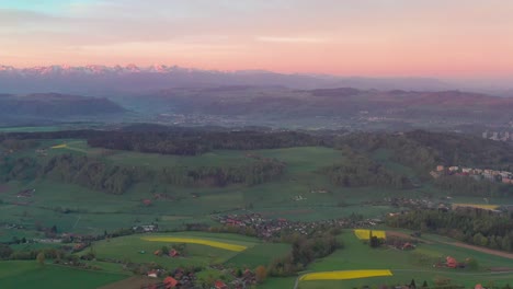 Aerial-drone-view-from-above-the-Bantiger-TV-tower-near-berne-on-a-gorgeous-morning-with-dramatic-sunrise-colors-and-lush-mountain-views-
