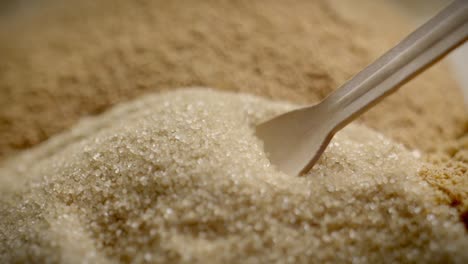 Close-Up-Slow-Motion-Shot-Of-Wooden-Spoon-Scooping-Brown-Sugar