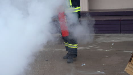 Unrecognizable-Firefighter-Practice-using-fire-extinguisher-to-extinguish-fire-in-slow-motion