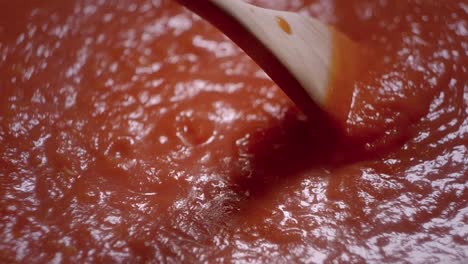 Mixing-In-Circle-Boiled-Red-Tomato-Sauce-With-wooden-Ladle