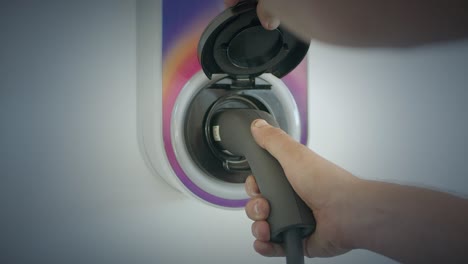 Close-Up-Of-Hands-Opening-Cover-Up-To-Connect-Into-Home-Wall-Electric-Charge