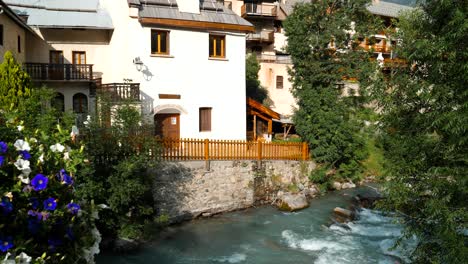 Facades-of-houses-lining-a-mountain-stream-in-the-Alps