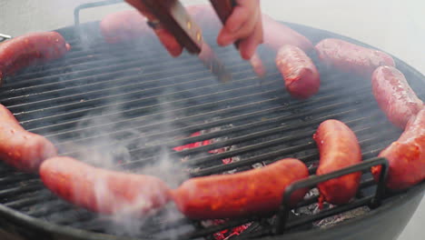 Panning-Shot-of-Rolling-Mexican-Grill-Sausage-Surrounded-by-Ring-of-Sausage-on-BBQ