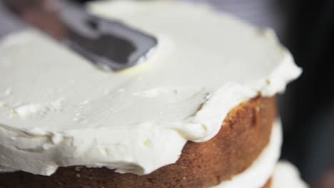 baker-smooths-buttercream-on-cake-slow-mo