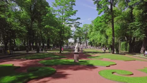 Summer-Garden,-an-aerial-drone-footage-of-a-beautiful-central-park-with-a-monument-and-fountain-from-ground,-people-visiting-the-festival