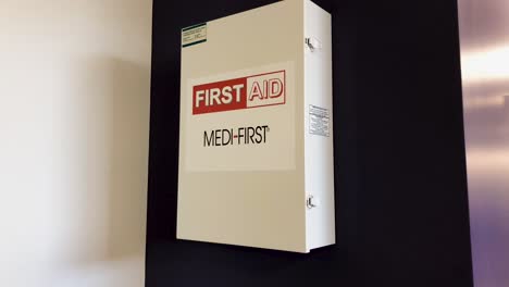 First-aid-kit-mounted-to-a-purple-wall-in-an-office-setting