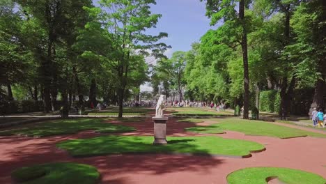 Summer-Garden,-an-aerial-drone-footage-of-a-statue-from-Greece-in-a-central-alley,-near-Crowning-Fountain,-beautiful-landscape-deisgn-from-Royal-Russia
