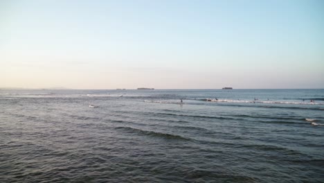 Distant-view-of-surfers-riding-waves