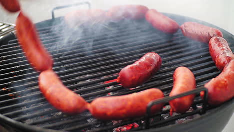 Panning-Shot-of-Rolling-Mexican-Grill-Sausage-Surrounded-by-Ring-of-Sausage-on-BBQ