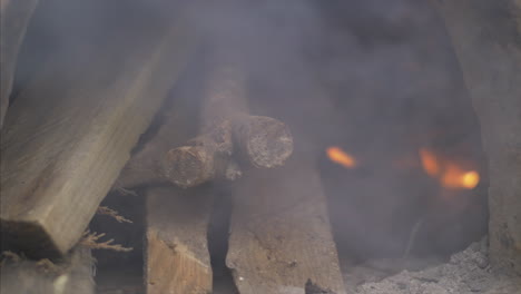 Close-Up-Shot-of-wood-burning-inside-the-clay-oven,-in-4K-Slowmotin