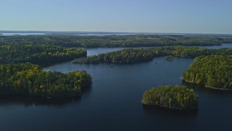 Epic-shot-of-a-nordic-forest-in-Finland,-national-park-with-islands-and-forest,-stone-shores-and-deep-blue-water