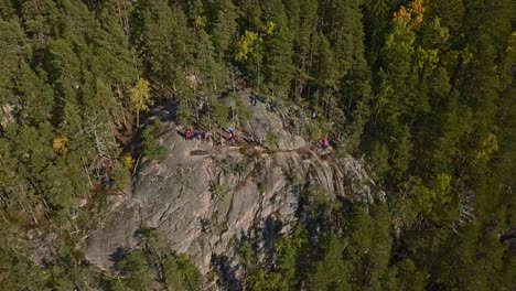 Mountain-in-a-forest,-national-park-of-Finland,-people-and-tourists-at-the-peak