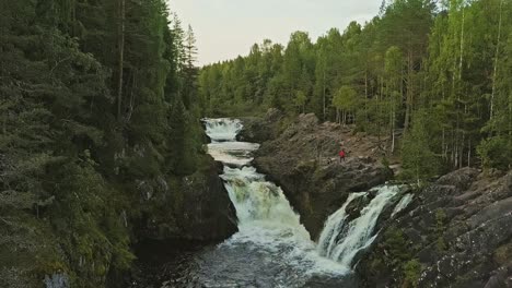 Aerial-footage-of-a-Karelian-waterfall-Kivach,-full-water-stream-main-view,-beautiful-nature,-foam-on-water