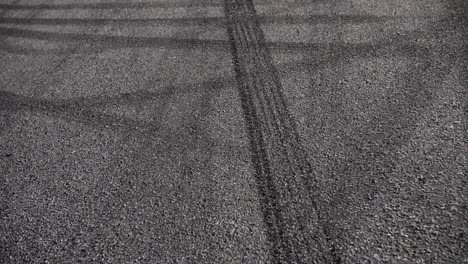 Drift-marks-on-an-asphalt-from-drift-tires,-slow-motion-fly-by