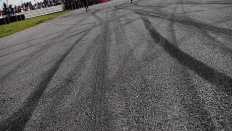 Drift-marks-on-an-asphalt-from-drift-tires,-slow-motion-fly-by