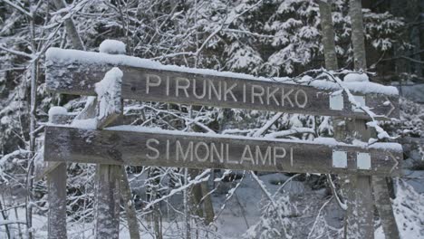Pirunkirkko-and-simonlampi-signs-in-winter-forest-in-Finland