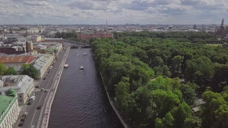 Saint-Petersburg,-an-aerial-drone-footage-of-a-boat-in-a-river,-channel,-Church-of-Savior-on-Blood,-Castle,-center-of-Saint-Petersburg,-overview-shot-on-the-city-in-summer