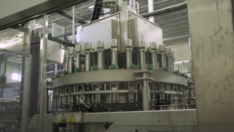 Large-spinning-machinery-at-packaging-factory,-WIDE