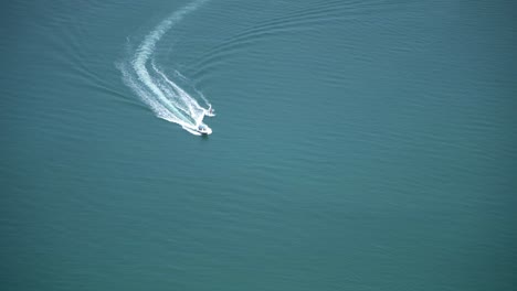 View-from-a-hostel-on-the-66th-floor-of-a-building-in-Dubai-of-two-people-water-skiing-behind-a-boat-in-the-ocean