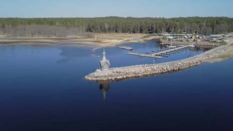Rocky-shore-with-a-small-Orthodox-chapel-aerial-view