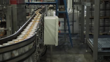 Aluminium-cans-moving-through-converyor-belt-in-packaging-factory