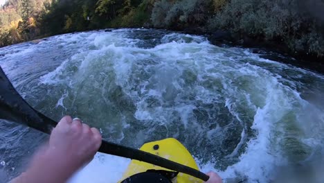 White-water-kayaking-on-a-river-surf-wave