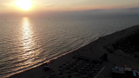 Ascending-drone-shot-of-sunset-over-the-sea