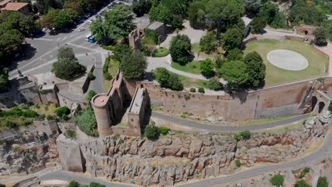 Panning-down-aerial-view-of-a-medieval-fortress-with-a-park-in-the-centre