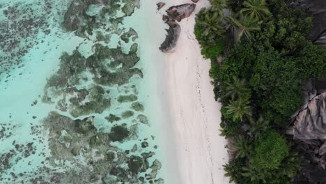 Aerial-view-of-Anse-Source-d’Argent,-La-Digue,-Seychelles-shot-in-the-early-morning-hours-with-no-people-on-the-beach
