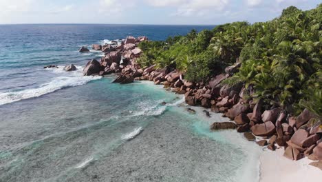 Aerial-view-of-the-white-beaches-and-turquoise-waters-at-Anse-Coco,-Petit-Anse-and-Grand-Anse-on-La-Digue,-an-island-of-the-Seychelles