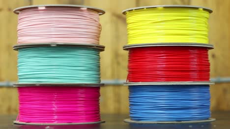 Two-piles-of-3D-Printer-filament-sit-on-a-workbench