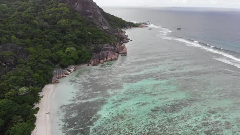 Aerial-view-of-Anse-Source-d’Argent,-La-Digue,-Seychelles-shot-in-the-early-morning-hours-with-no-people-on-the-beach