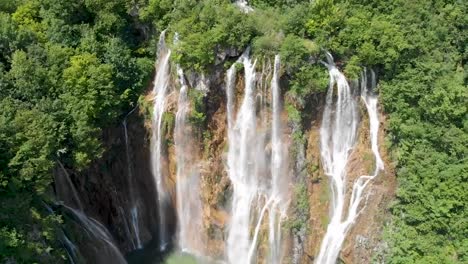 Pull-back-drone-shot-of-a-tall-waterfall