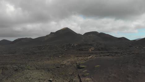 Flying-towards-a-series-of-volcanic-hills-in-cloudy-weather