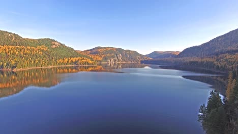 Aerial-shot-of-a-Drone-flying-in-and-out-of-shot-on-a-Lake-in-Montana-in-the-Fall-or-Autumn