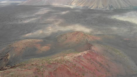 Aerial-view-of-a-red-volcanic-landscape-on-a-cloudy-day