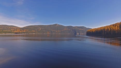Aerial-Drone-Shot-in-Montana-on-a-lake-with-a-boat-in-the-Fall-or-Autumn