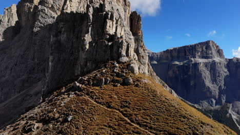 Drone-flying-up-face-of-Dolomite-mountain-in-Italy