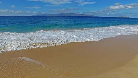 Panorámica-De-Las-Olas-Rompiendo-En-La-Playa-De-Arena-En-Maui-Hawaii-Con-Un-Hermoso-Cielo-Y-Agua