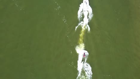Straight-down-aerial-view-of-wakeboarder-on-the-river-of-Port-Elizabeth,-South-Africa