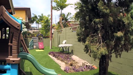 Suburban-backyard-with-kids-playhouse-on-a-windy-day