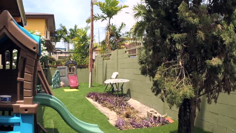 Suburban-backyard-with-kids-playhouse-on-a-windy-day