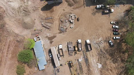 Overhead-aerial-shot-of-a-construction-site-in-the-middle-of-the-forest