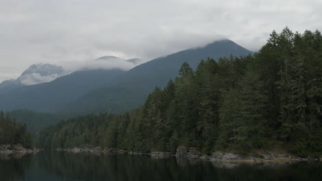 Wide-shot-of-a-British-Columbia-shoreline-and-mountain-peak
