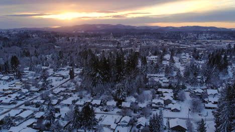 4k-Drone-flying-over-snow-covered-landscape-with-trees-and-houses-under