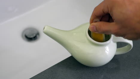 Salt-being-mixed-with-distilled-water-in-a-neti-pot