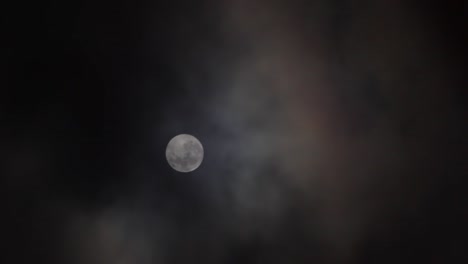 Clouds-pass-in-front-of-Full-Moon-in-a-dark-sky