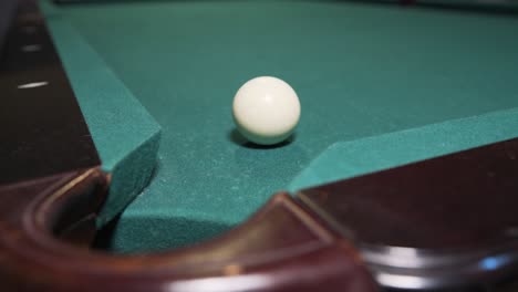 Player-sinking-black-8-ball-into-corner-pocket-to-win-game-of-billiards